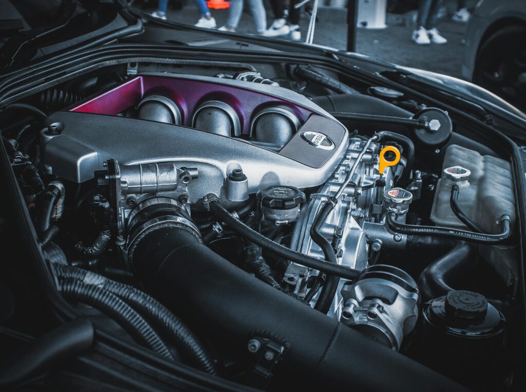 Detailed shot of a Nissan car engine bay featuring intricate engine parts and components.